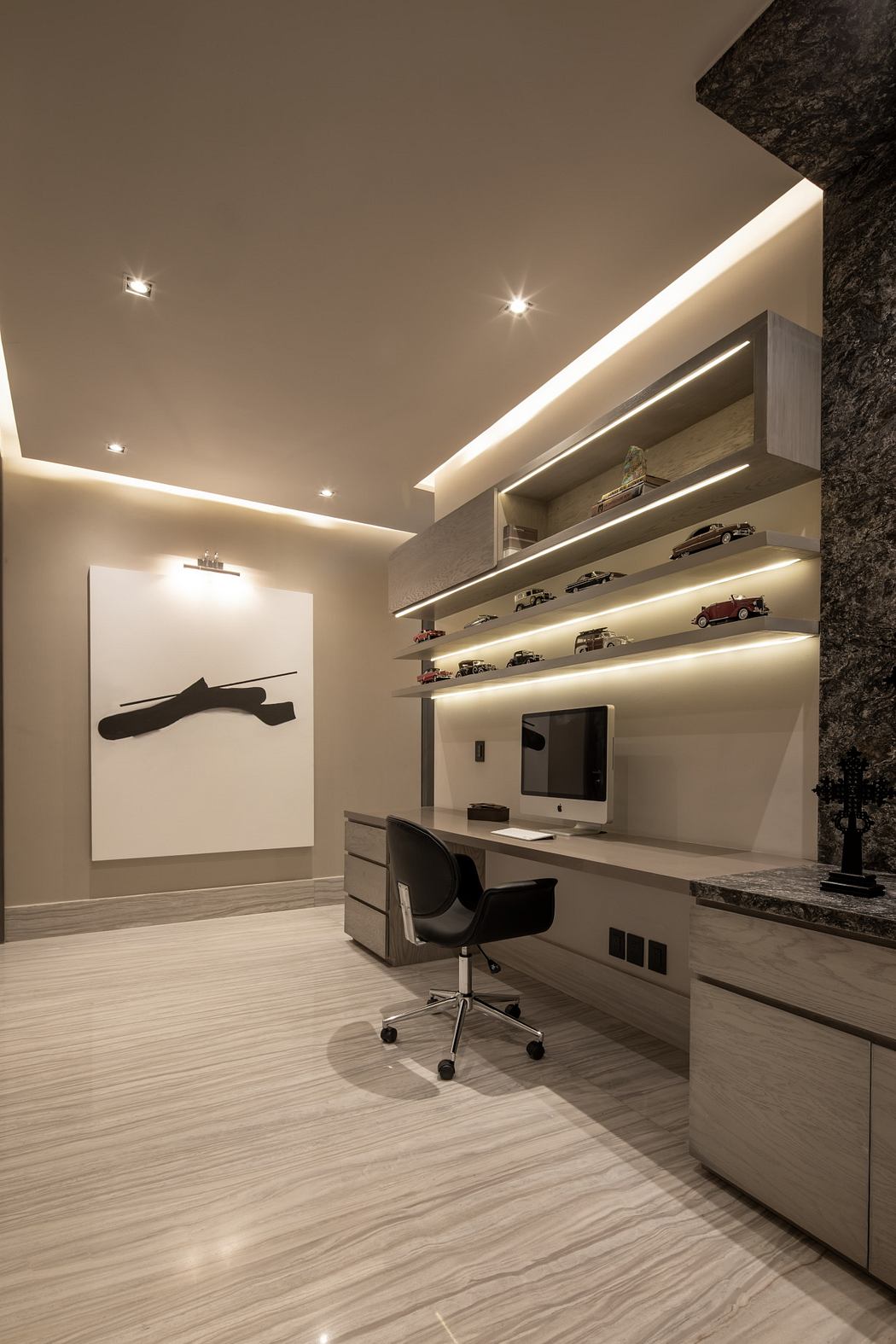 Sleek, modern home office with recessed lighting, floating shelves, and a minimalist design.
