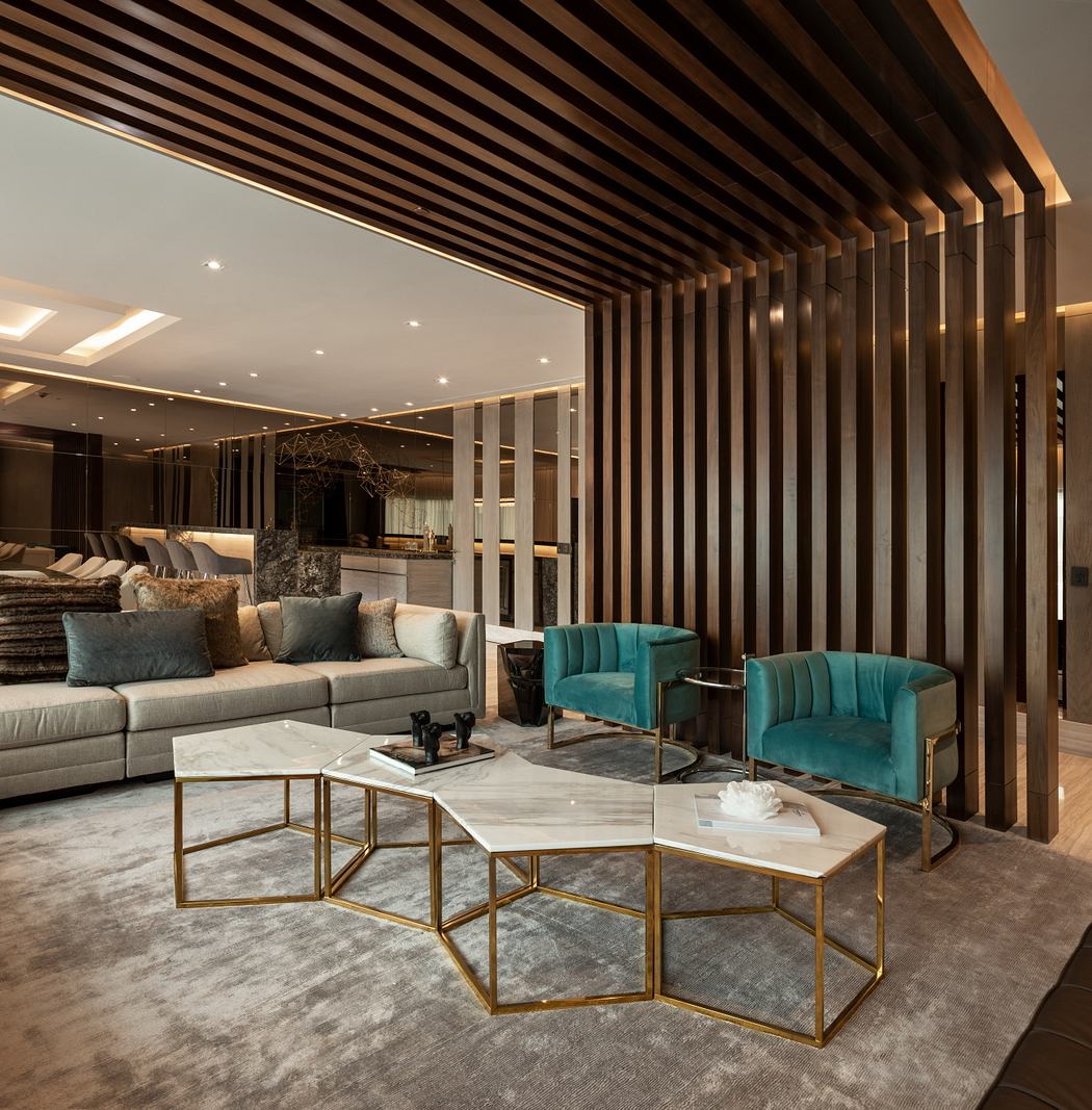 Elegant modern lounge with wood-paneled ceiling, plush seating, and a geometric marble coffee table.