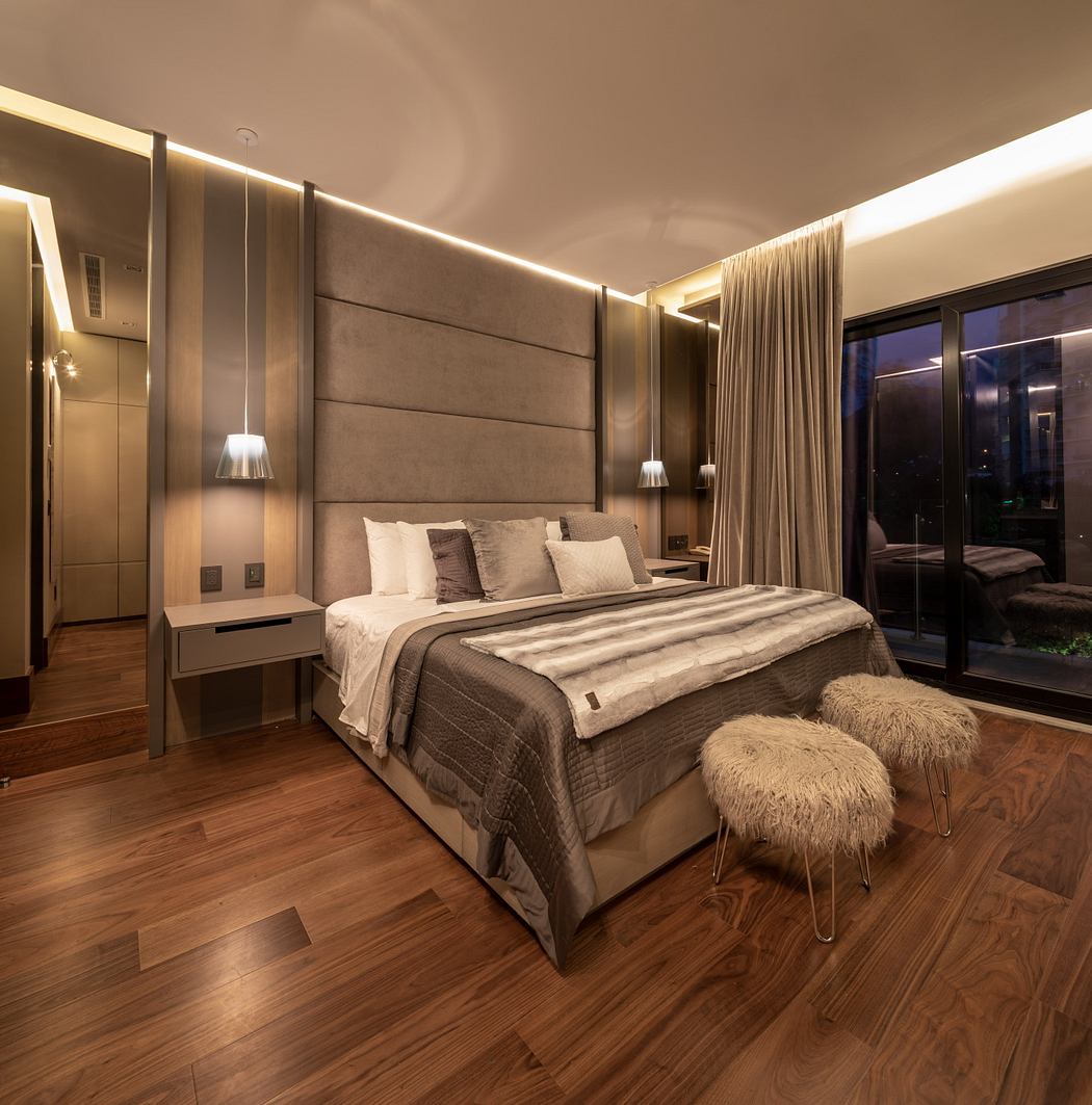Luxurious bedroom with plush bedding, warm lighting, and wooden flooring. Elegant minimalist design.