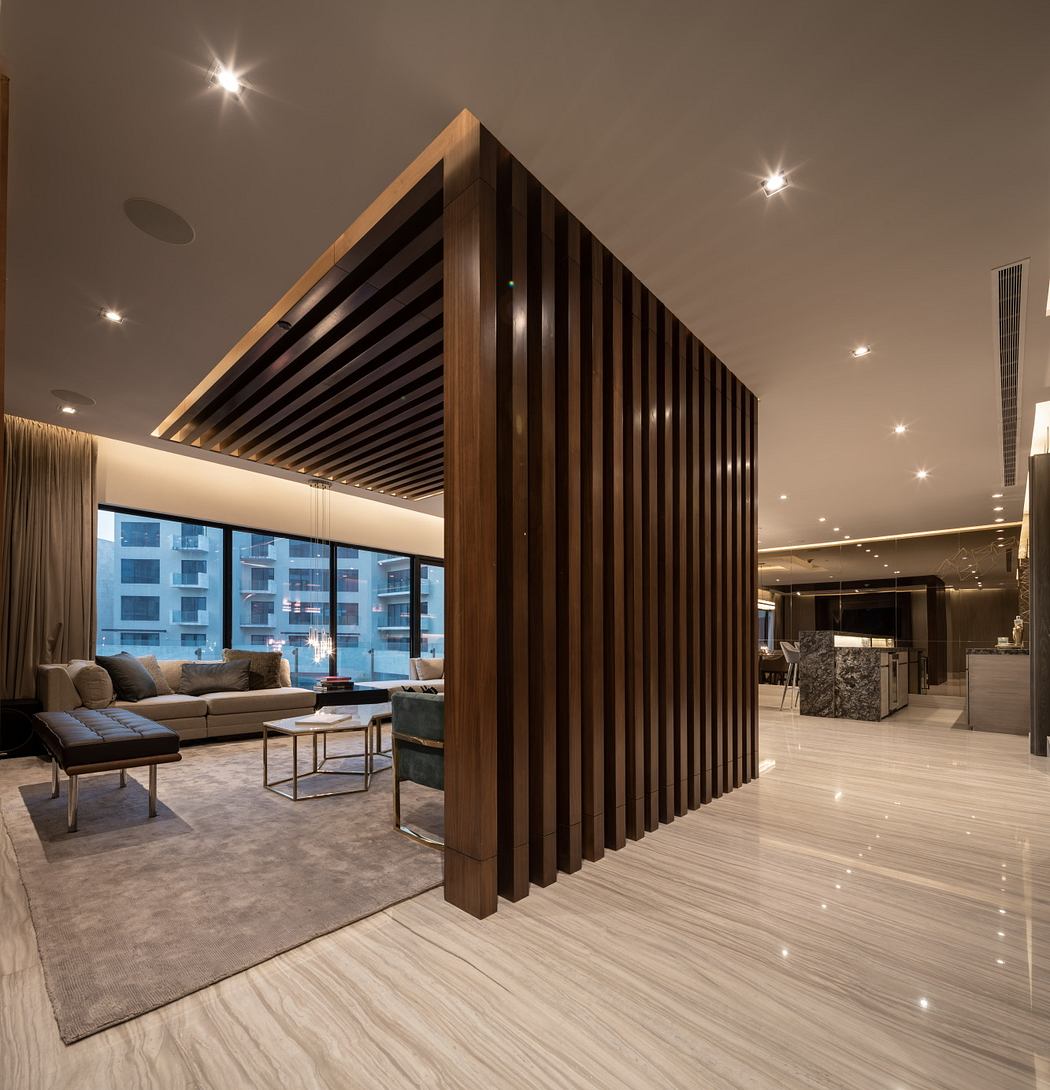 Sleek wooden slat partition divides the luxurious modern living space and kitchen.