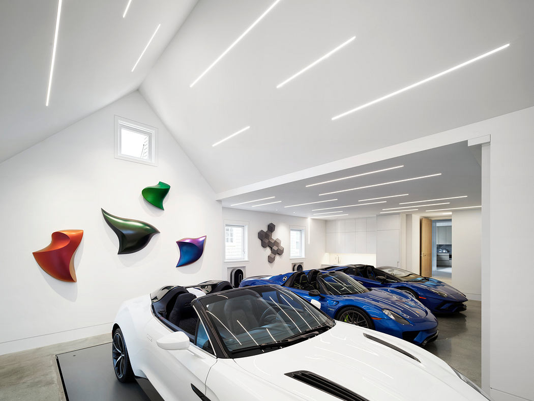 Sleek, modern interior with minimal lighting design and exotic sports cars displayed.