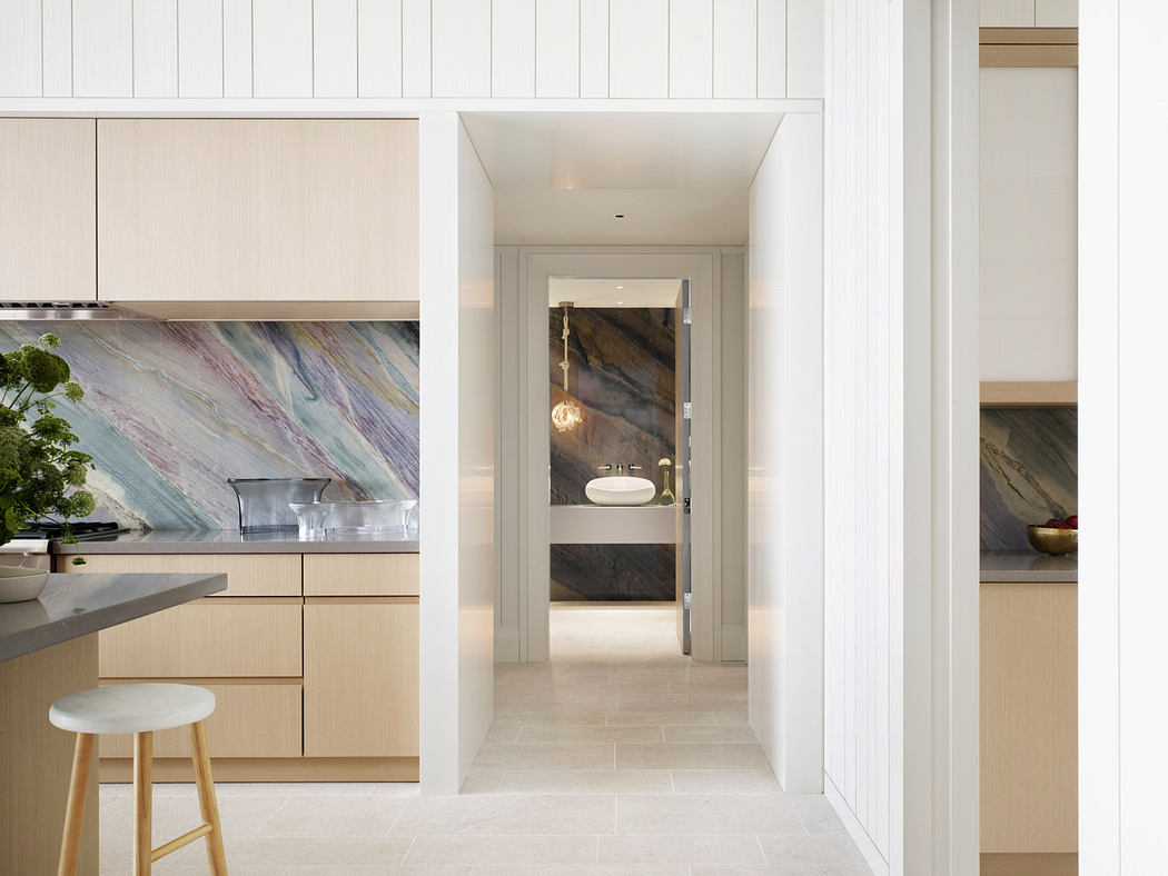 Contemporary kitchen with open floor plan, marble backsplash, and integrated lighting.