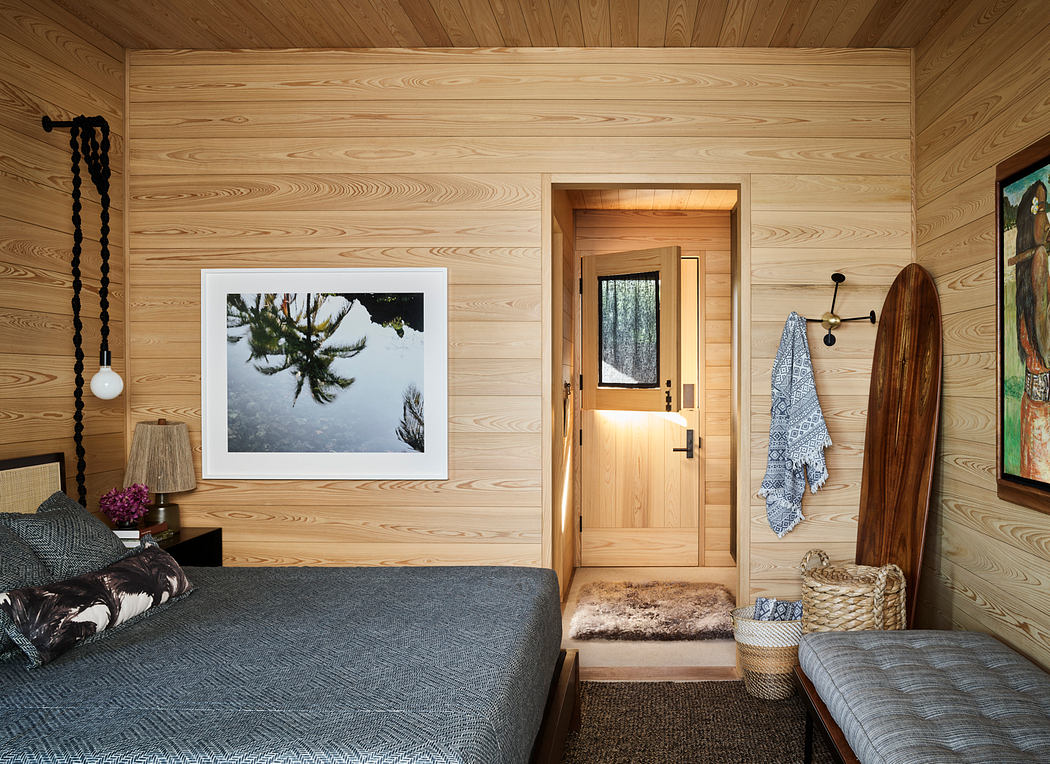 Rustic wooden cabin interior with cozy textiles, artwork, and entryway visible.