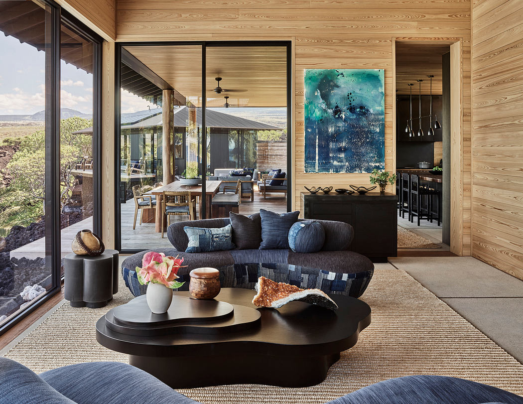 Cozy rustic cabin with expansive glass walls, wooden paneling, and minimalist decor.