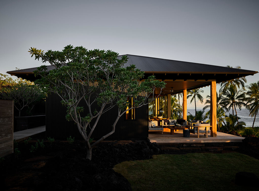A modern tropical retreat with a roofed terrace, wooden posts, and lush vegetation.