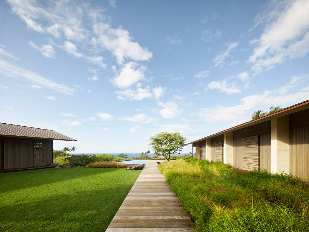 Coastal bungalows with wooden pathways, lush greenery, and panoramic ocean views.