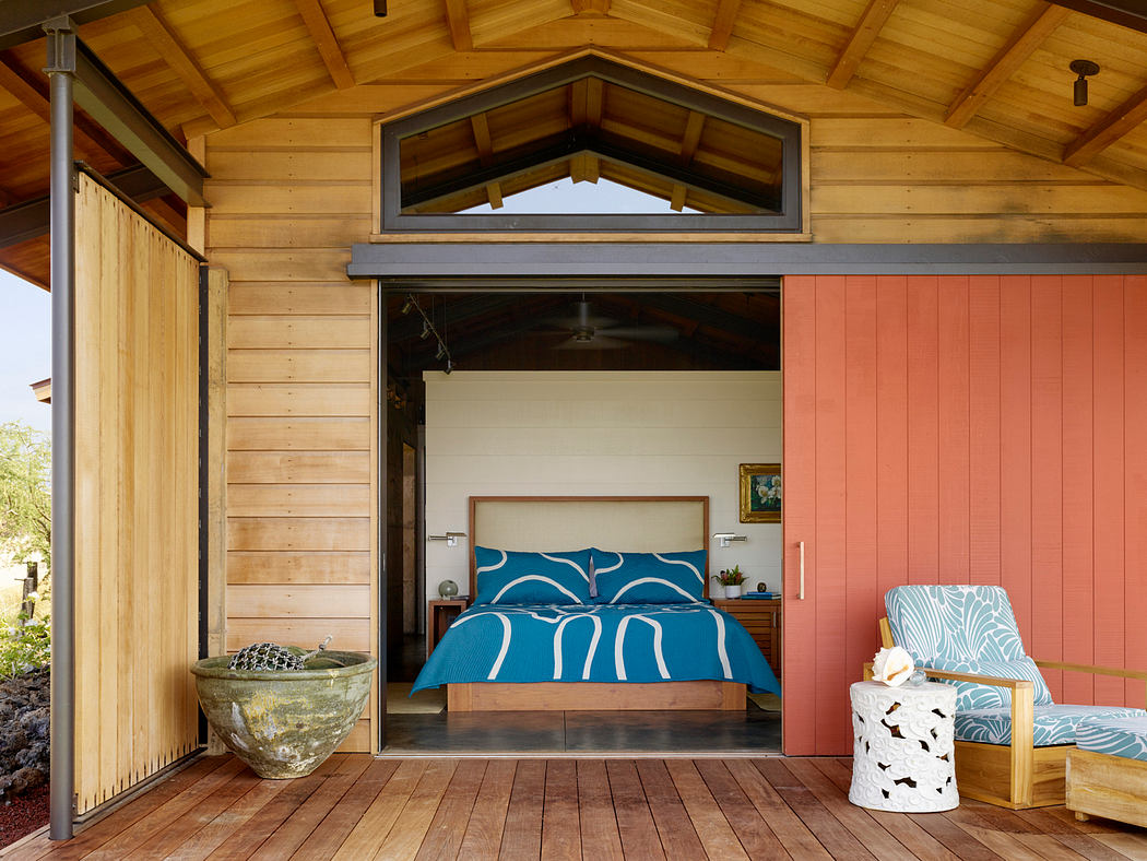 A cozy wooden cabin interior with a rustic charm, featuring a patterned bed and modern accents.