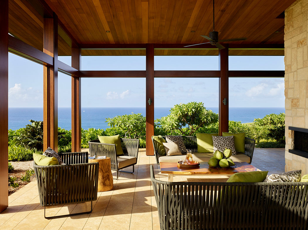 Well-designed outdoor living space with floor-to-ceiling windows, tropical plants, and comfortable seating.