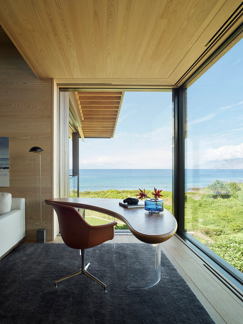 Expansive ocean view through floor-to-ceiling windows, wooden ceiling and furnishings.