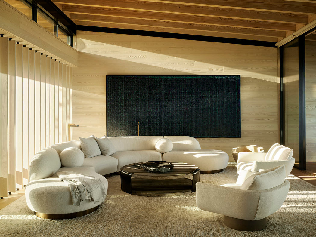 Cozy living room with wooden beams, plush sofas, and a large TV screen against the wall.