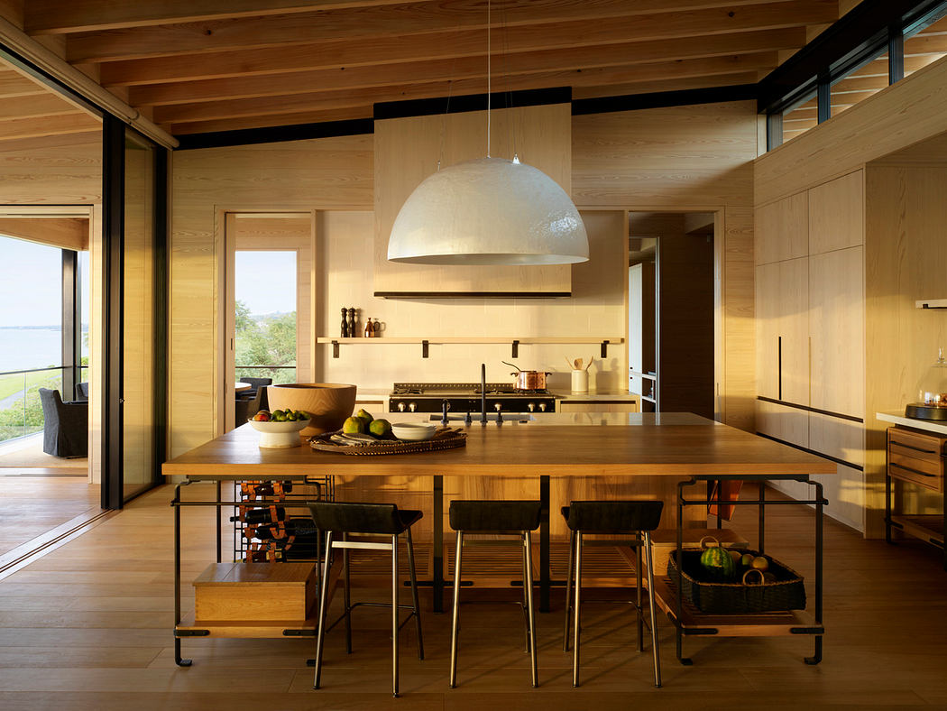 Spacious modern kitchen with wood accents, large island, and inviting lighting.