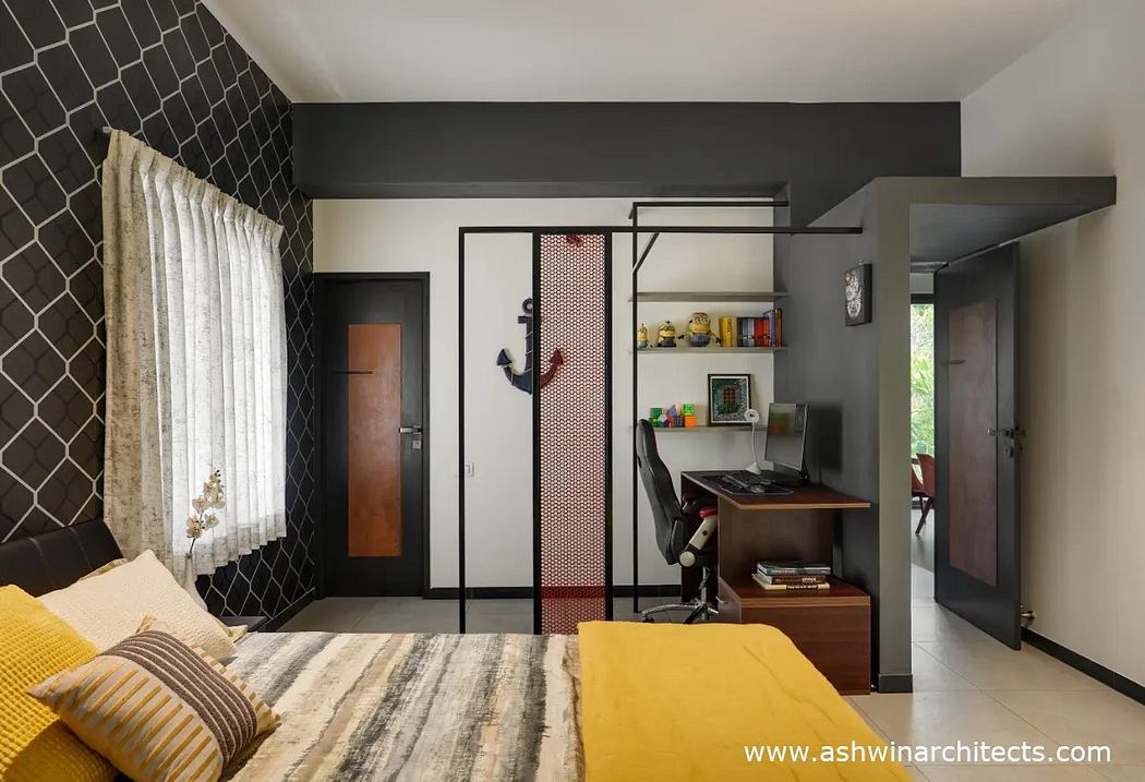 Modern bedroom with geometric black and white wall tiles, iron frame furniture, and warm color accents.