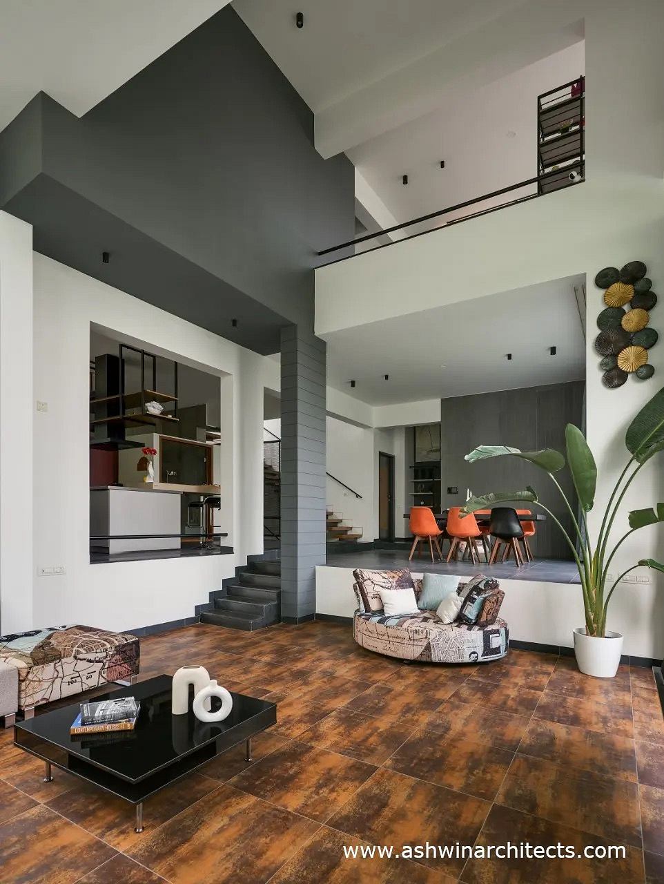 Minimalist modern interior design with sleek black and white accents, wood floors, and decorative wall art.