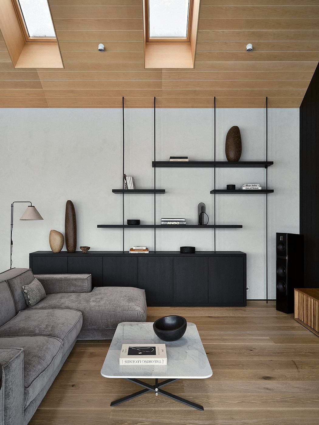 Minimalist living room with sleek black shelving, neutral palette, and natural wood accents.