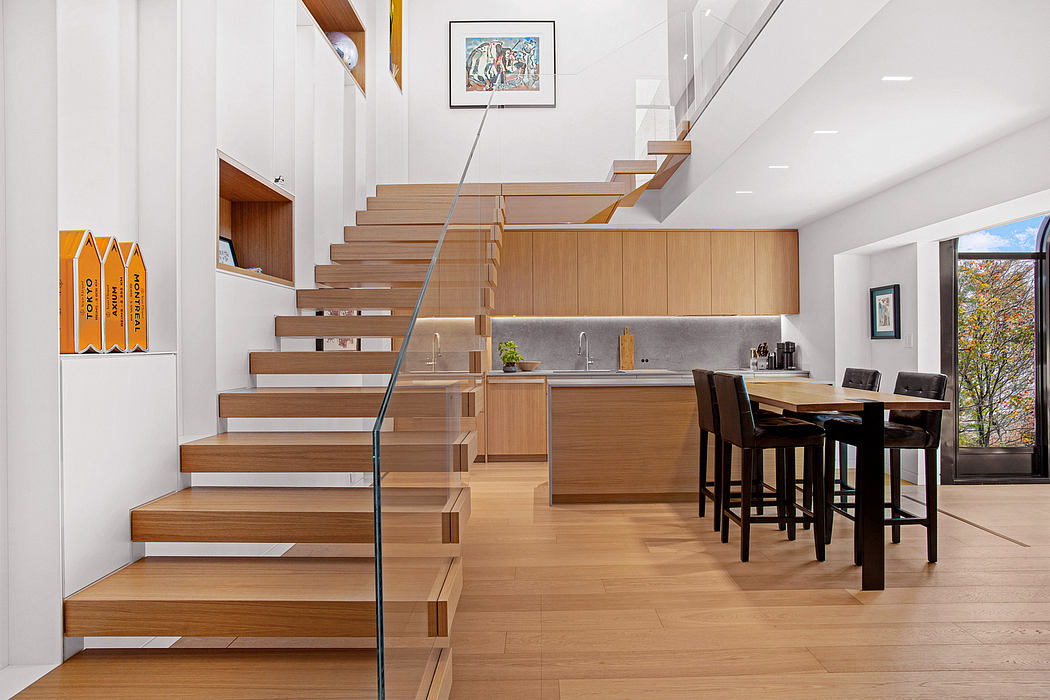 Modern kitchen and staircase design with wood accents and minimalist decor.
