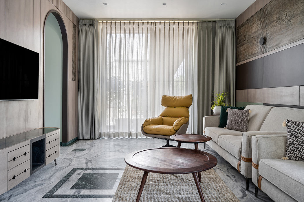 Spacious living room with modern furniture, large window, and textured walls.