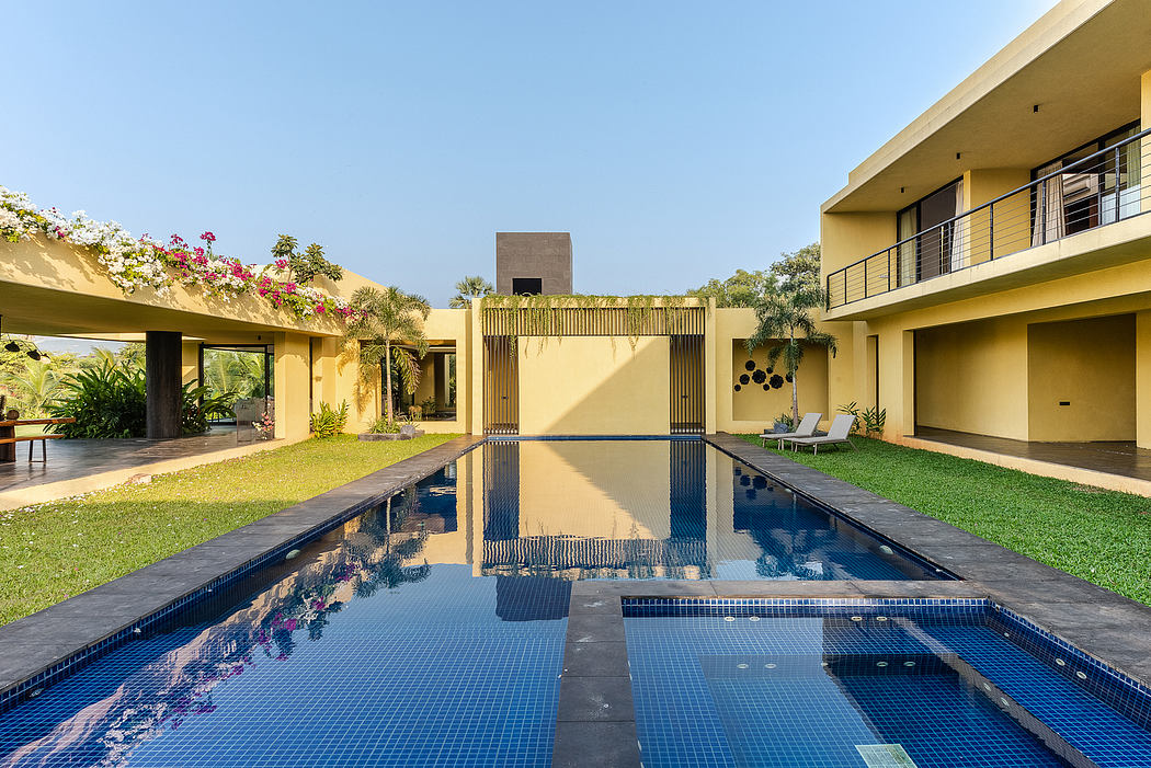 Modern tropical villa with tiered pool, lush landscaping, and architectural features.