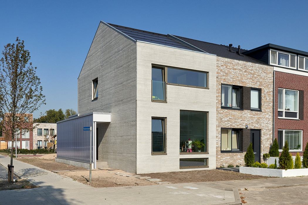 Modern multi-story residential building with sleek concrete and brick facade, large windows.