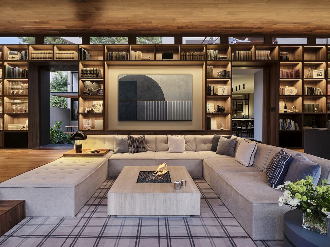 Spacious living room with built-in bookshelves, modern fireplace, and plush sectional sofa.