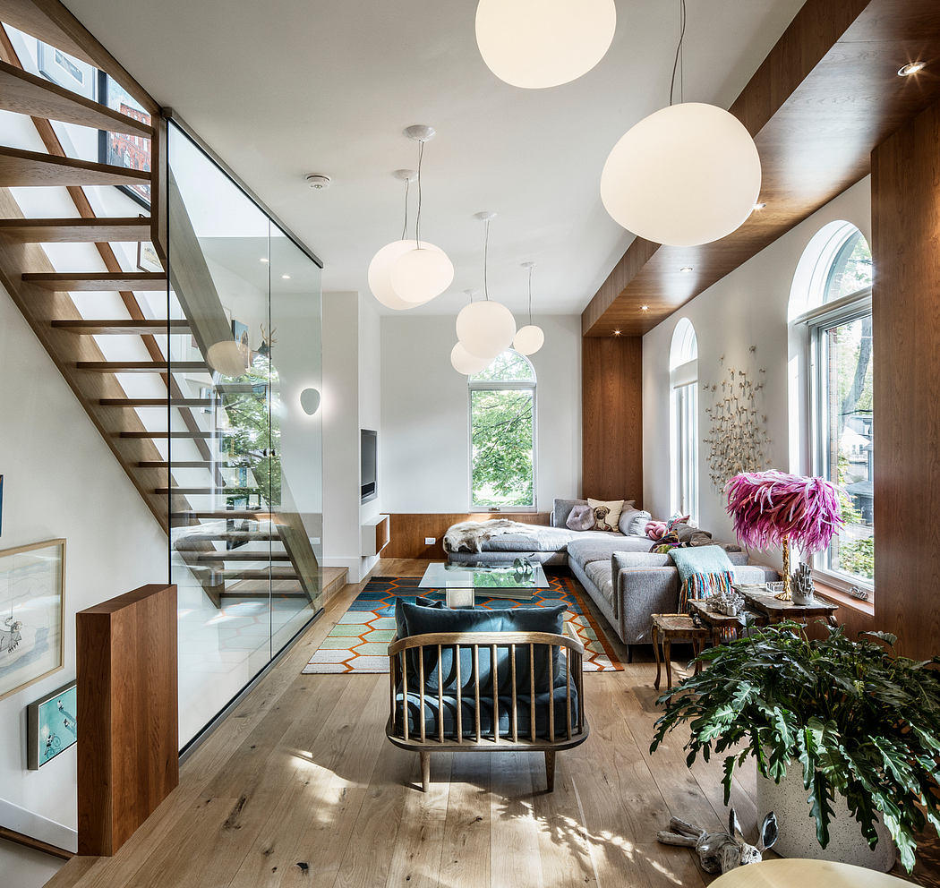 Bright, modern living space with wood beams, arched windows, and sculptural lighting.