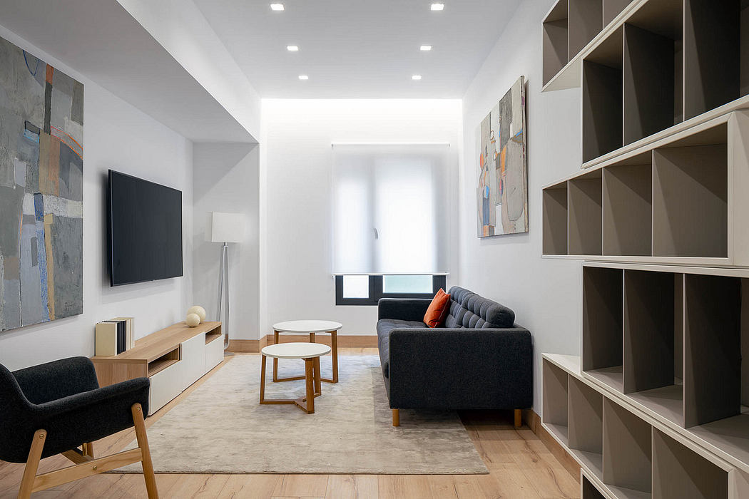 Spacious modern living room with minimalist furniture, built-in storage, and abstract artwork.