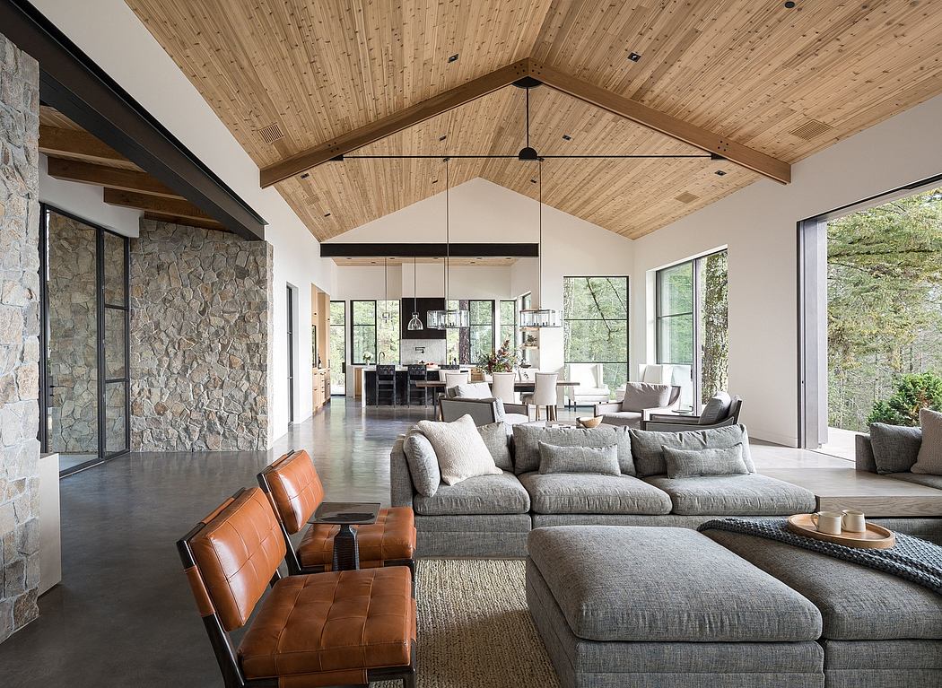 Warm, rustic living room with vaulted wood ceiling, stone wall, and cozy seating.