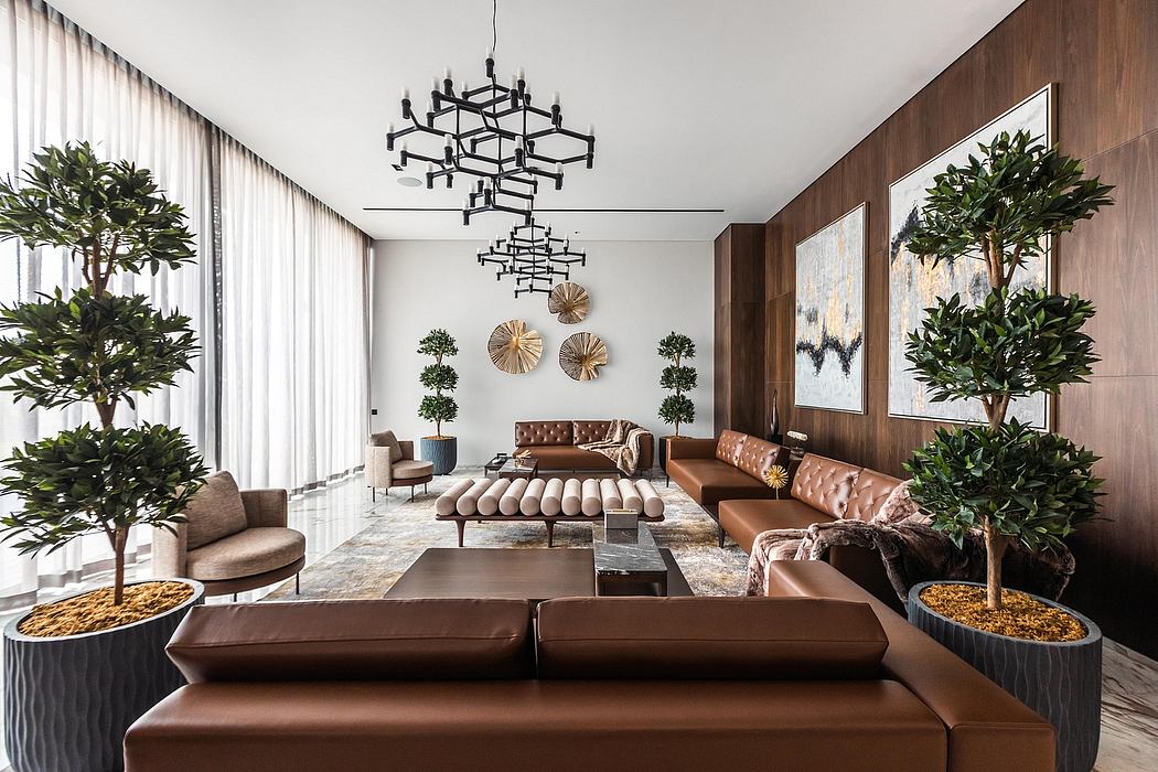Lavish living room with plush leather furniture, dramatic lighting, and lush greenery.