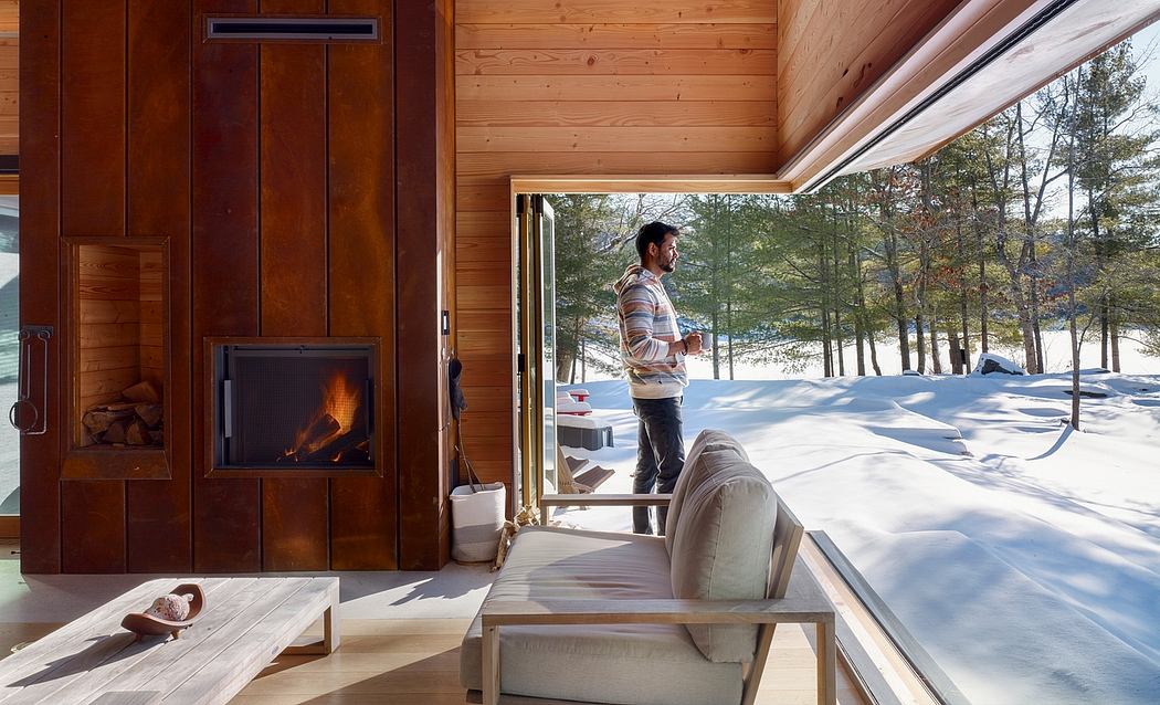 Cozy wooden cabin interior with fireplace and panoramic winter forest views.