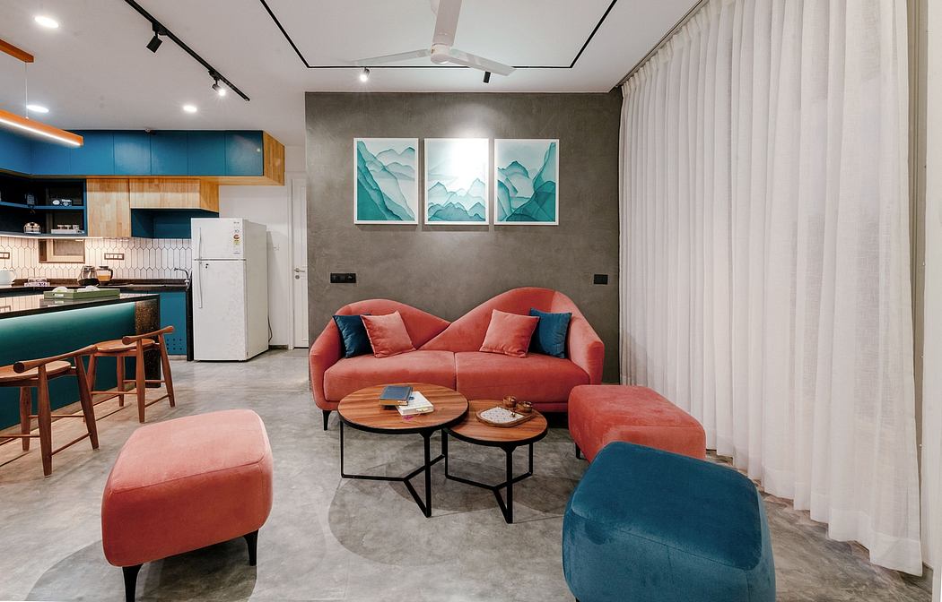 Modern living room with sleek furniture, vibrant accents, and minimalist mountain artwork.