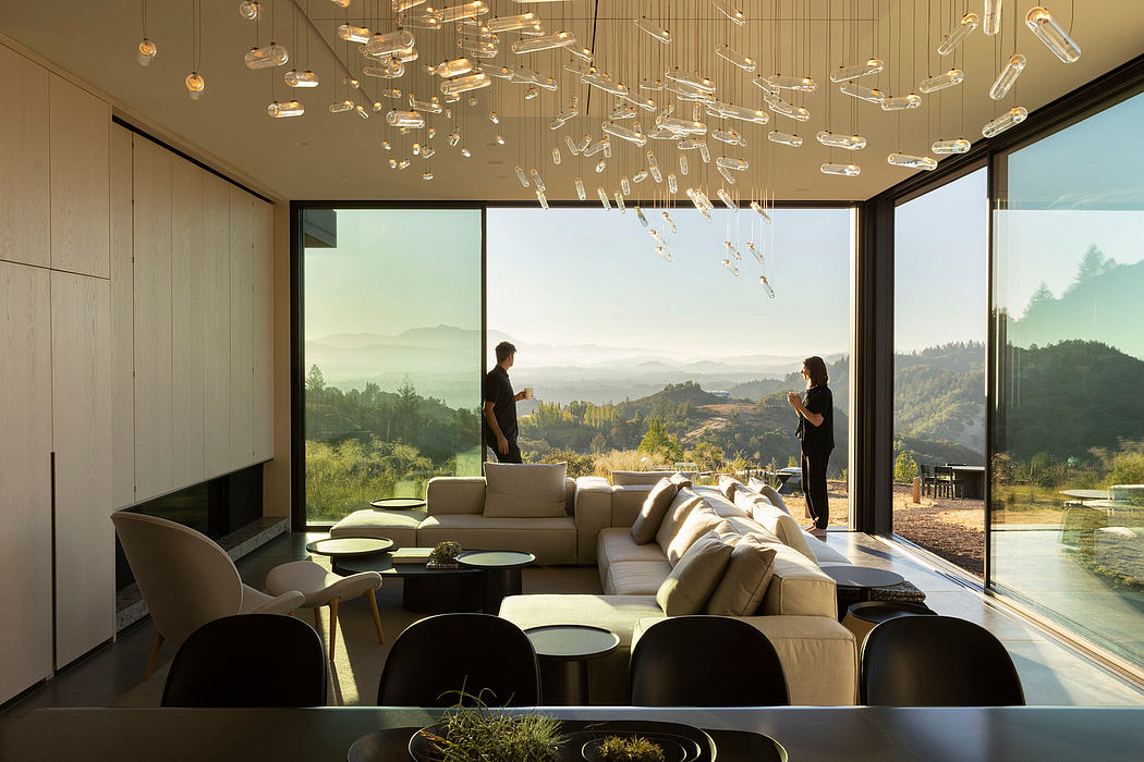Luxurious modern living room with large windows showcasing stunning mountain landscape.