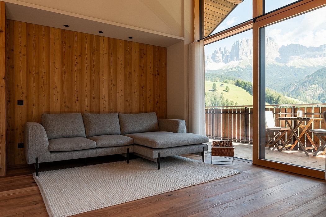 Cozy mountain chalet with wooden walls, sectional sofa, and panoramic views.