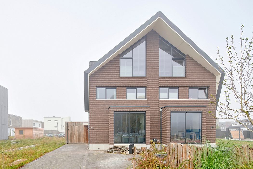 Striking modern architecture with asymmetrical roof, large windows, and wood accents.