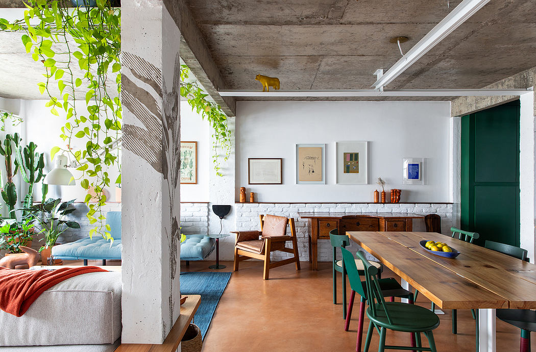 Eclectic loft-style interior with exposed concrete, lush greenery, and mix of modern and vintage furnishings.