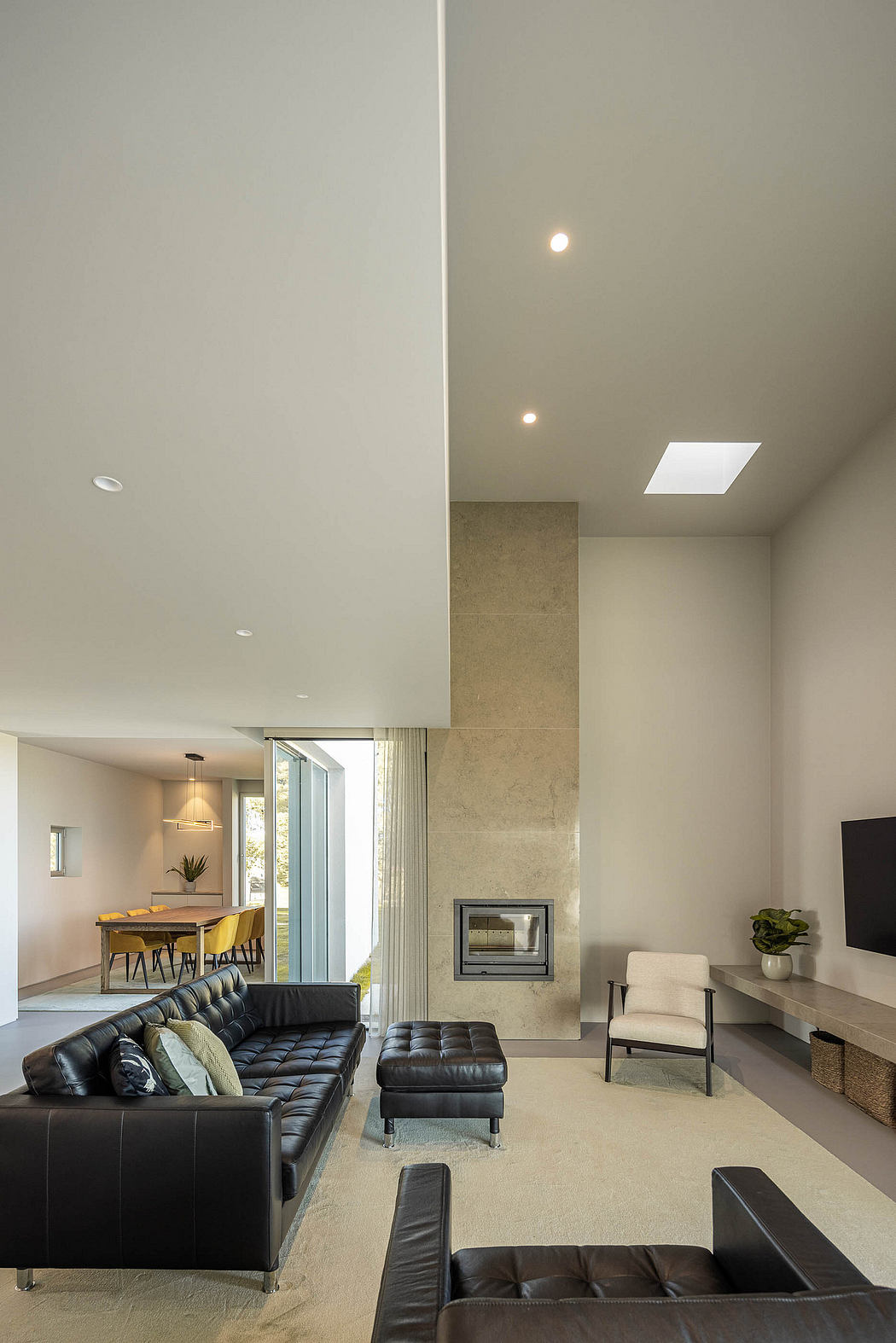 Spacious living room with modern furnishings, fireplace, and access to outdoor space.