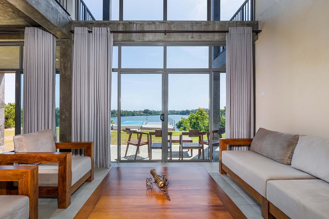 Spacious room with panoramic lake view, modern furniture, and wooden floor details.