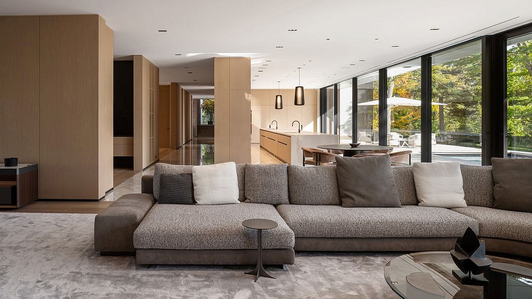 Expansive open-concept living space with large windows, modern furnishings, and sleek cabinetry.