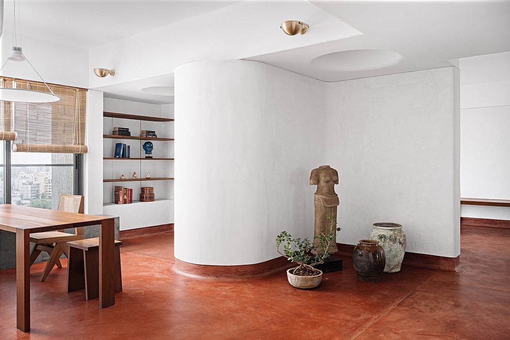 Minimalist, open-concept living space with wooden furnishings, shelves, and earthy decor accents.