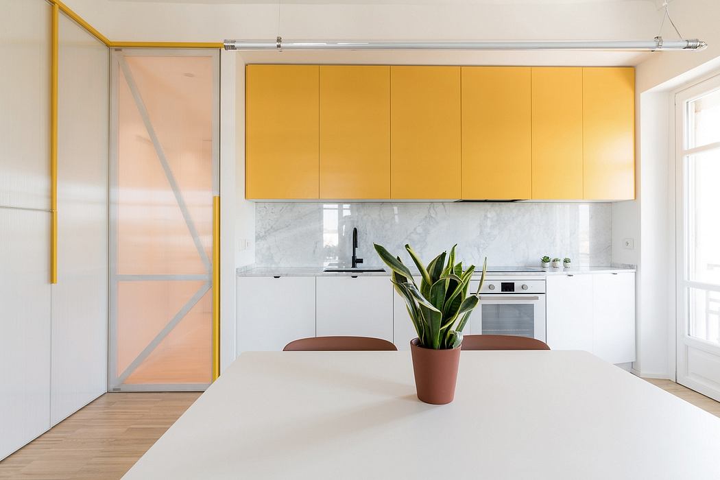 Bright, modern kitchen with yellow cabinets, marble backsplash, and sliding glass door.
