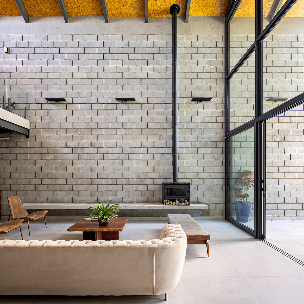 Spacious living room with exposed brick walls, modern fireplace, and glass sliding doors.