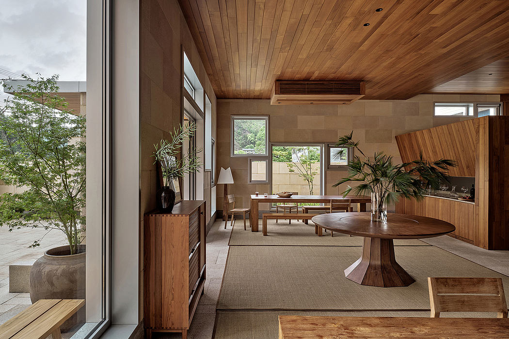 Warm, modern interior with wooden accents, large windows, and natural elements.