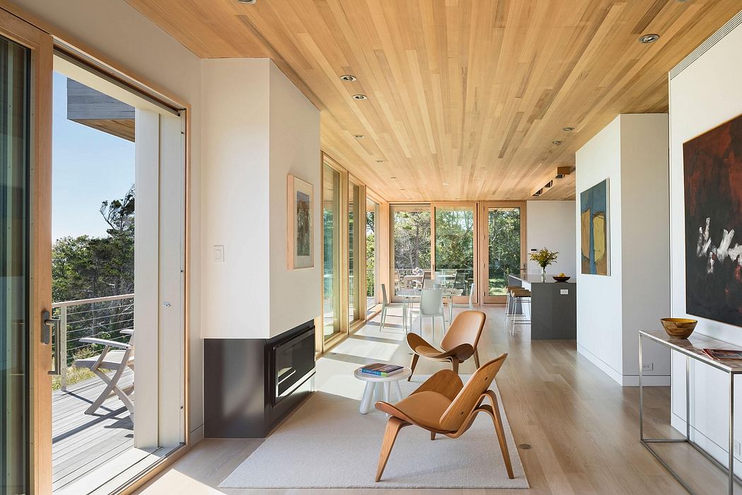 Spacious living room with wooden ceiling, large windows, and mid-century modern furniture.