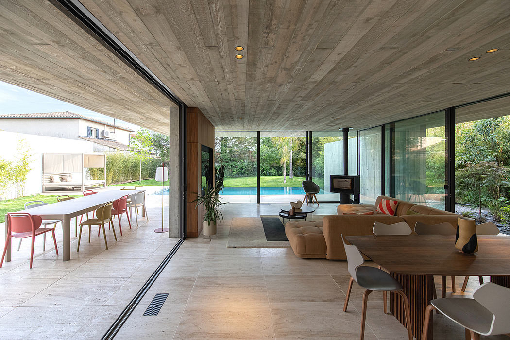 Airy, open-concept living space with concrete ceiling, large windows, and modern furnishings.