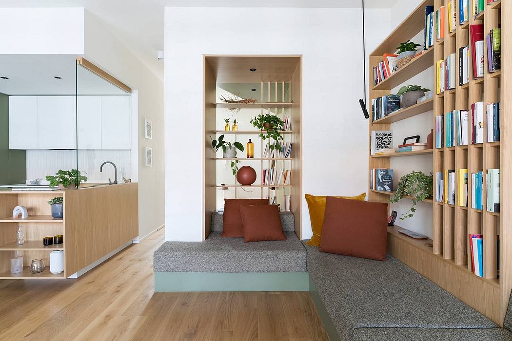Cozy, modern living space with built-in shelving, wood paneling, and colorful accents.