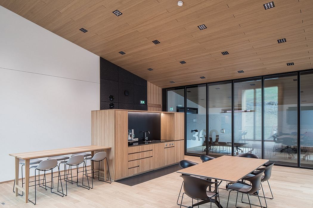 Sleek, modern office space with wooden paneled ceiling, glass walls, and minimalist decor.