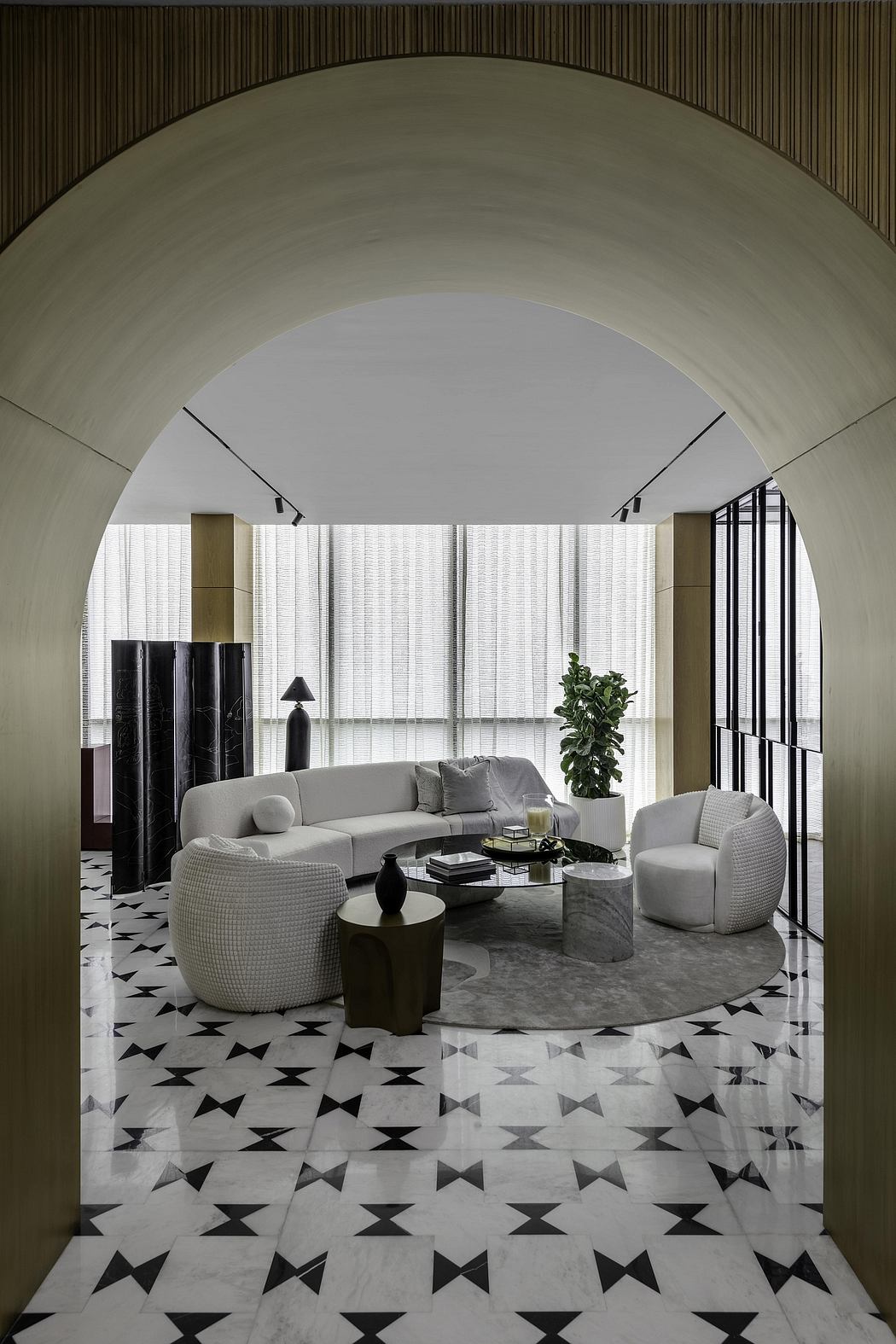 An elegant, modern living space with curved arched ceiling, patterned floor tiles, and plush furnishings.
