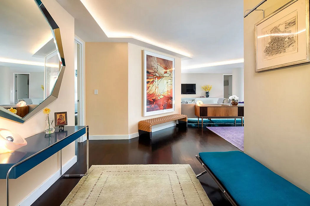 Spacious, modern interior with vibrant abstract artwork, sleek furnishings, and rich textures.