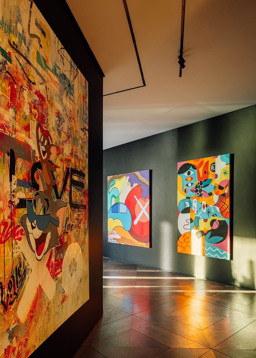 Vibrant, abstract wall art and geometric tile flooring in a modern gallery space.
