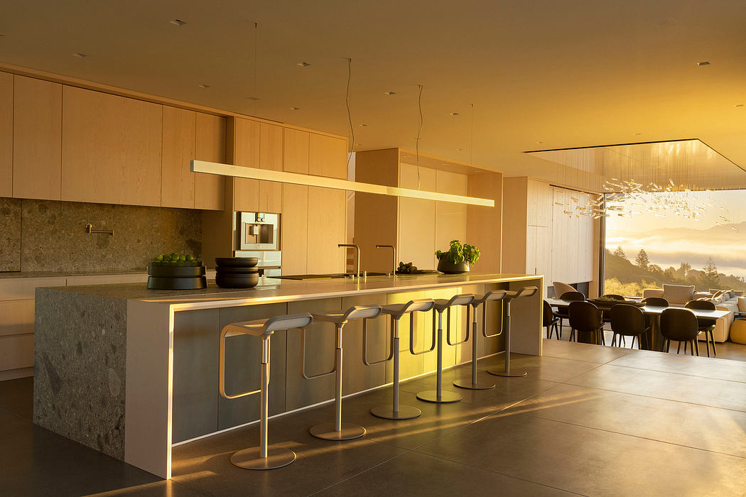 Sleek, contemporary kitchen with warm wood cabinetry, stone countertops, and pendant lighting.