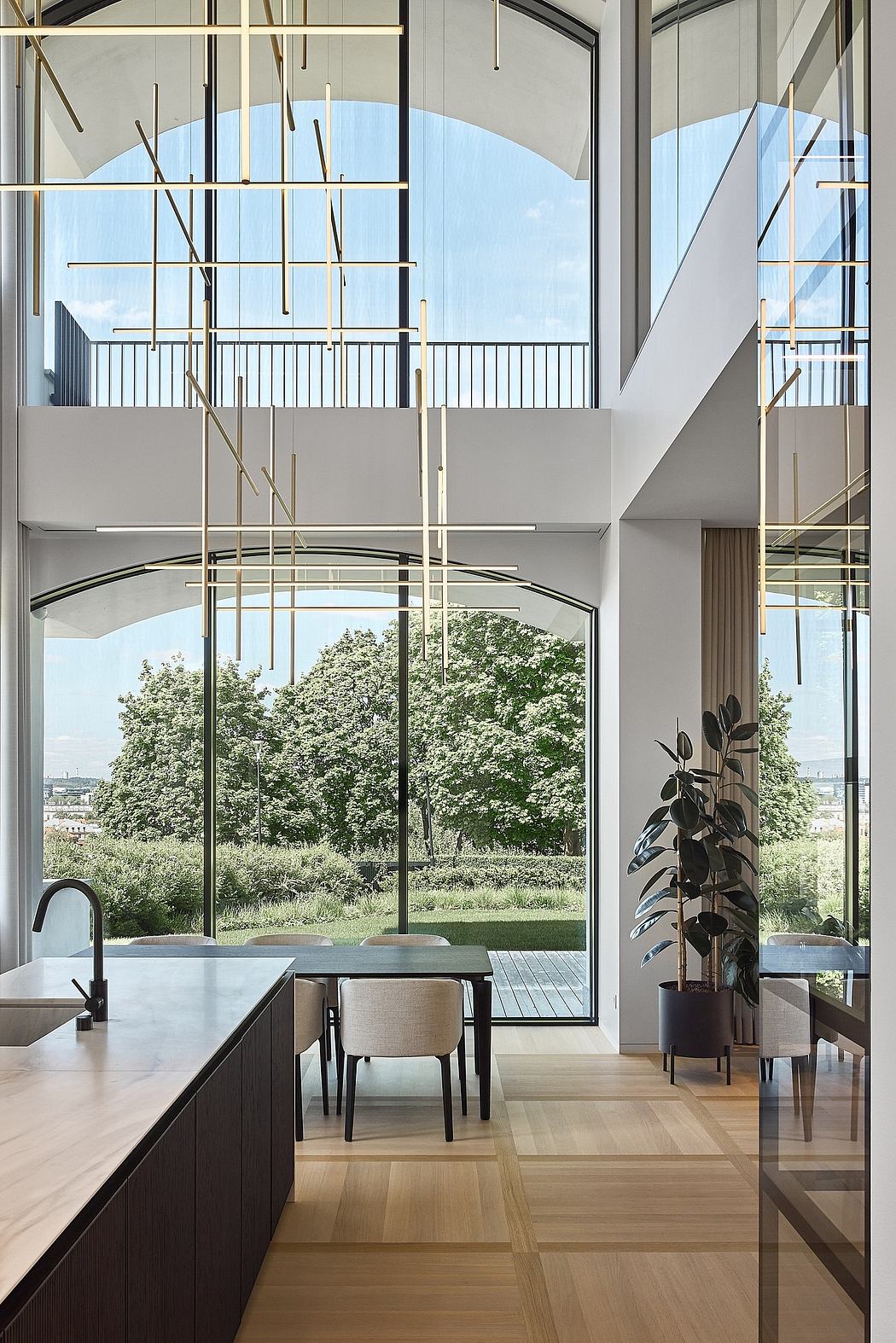 A modern, open-plan living space with large windows, sleek furniture, and a lush garden view.