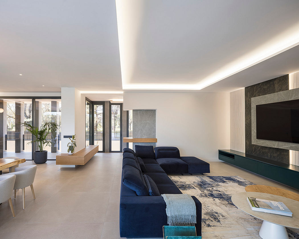 Modern, open-concept living space with sleek furniture, natural lighting, and marble accents.
